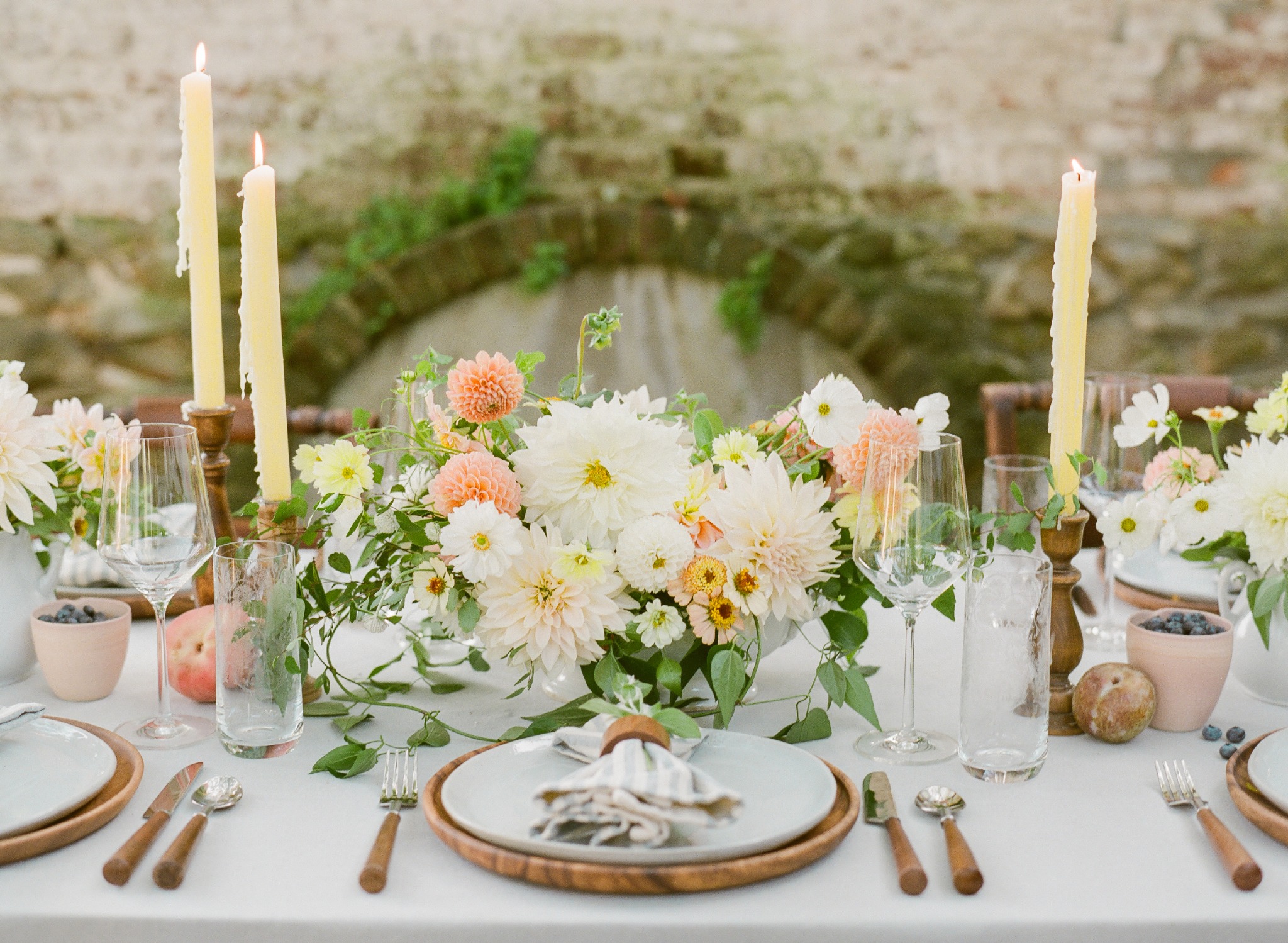 Garden flowers, candlelight, and place settings at a seasonal table